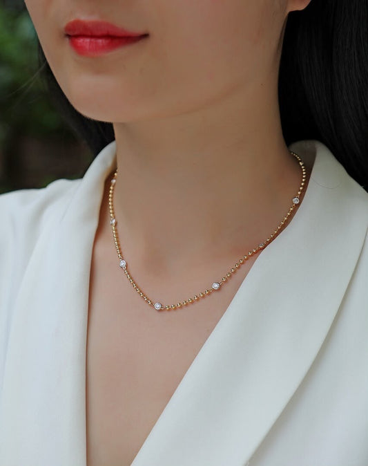 Golden orbit ball necklace